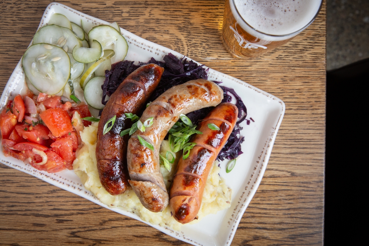 a plate of food with a glass of beer
