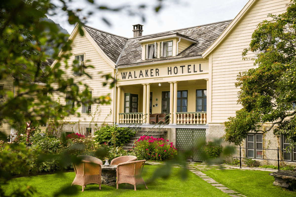 a hotel with a lawn and chairs