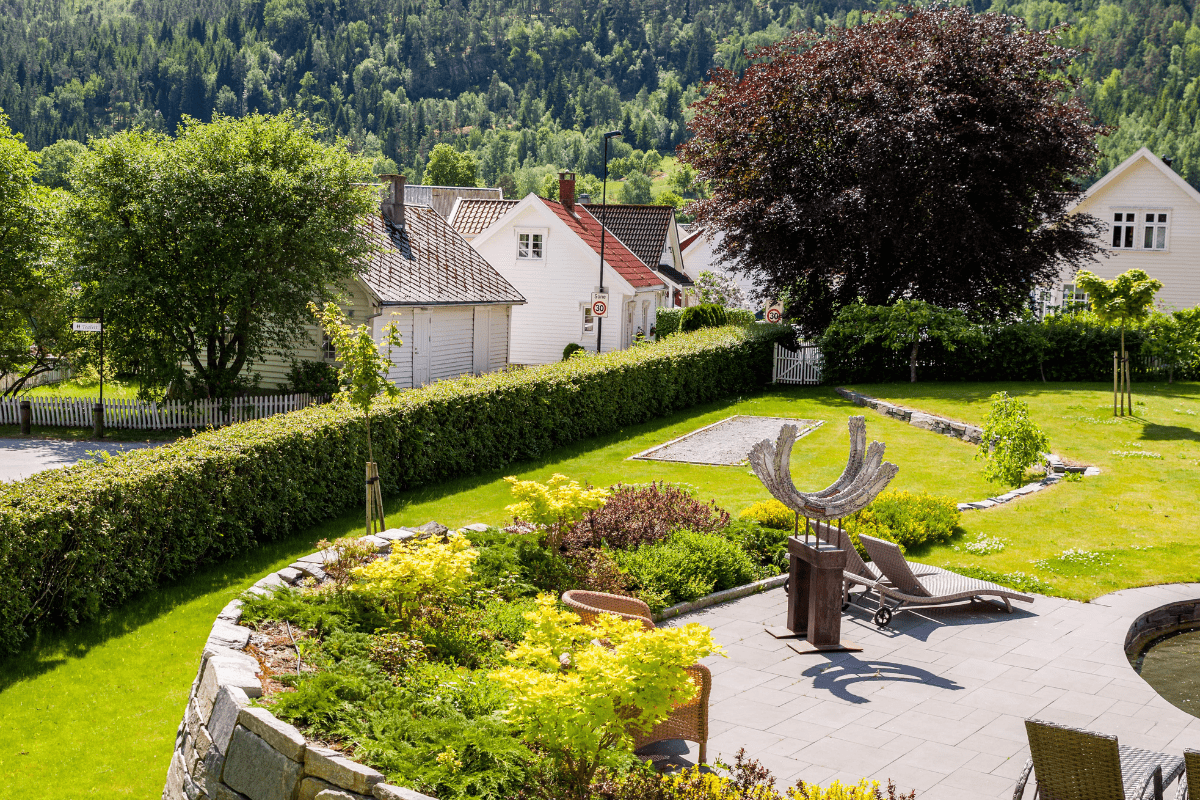 a garden with a stone patio and a stone wall with a stone wall and a stone fence with a stone wall and a stone wall with a stone wall with a stone wall and a stone wall with