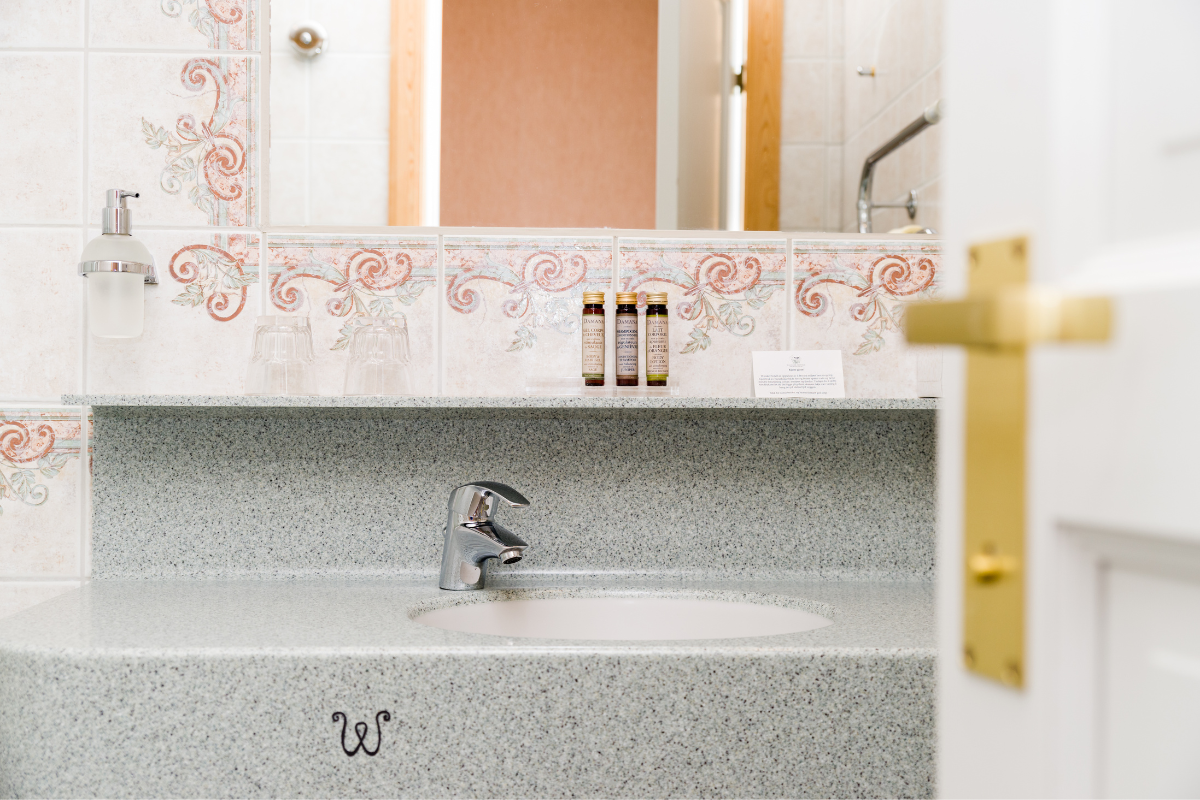 a bathroom sink with a faucet and a mirror