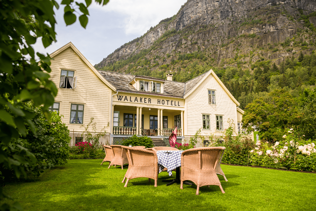 a hotel with a table and chairs in front of it
