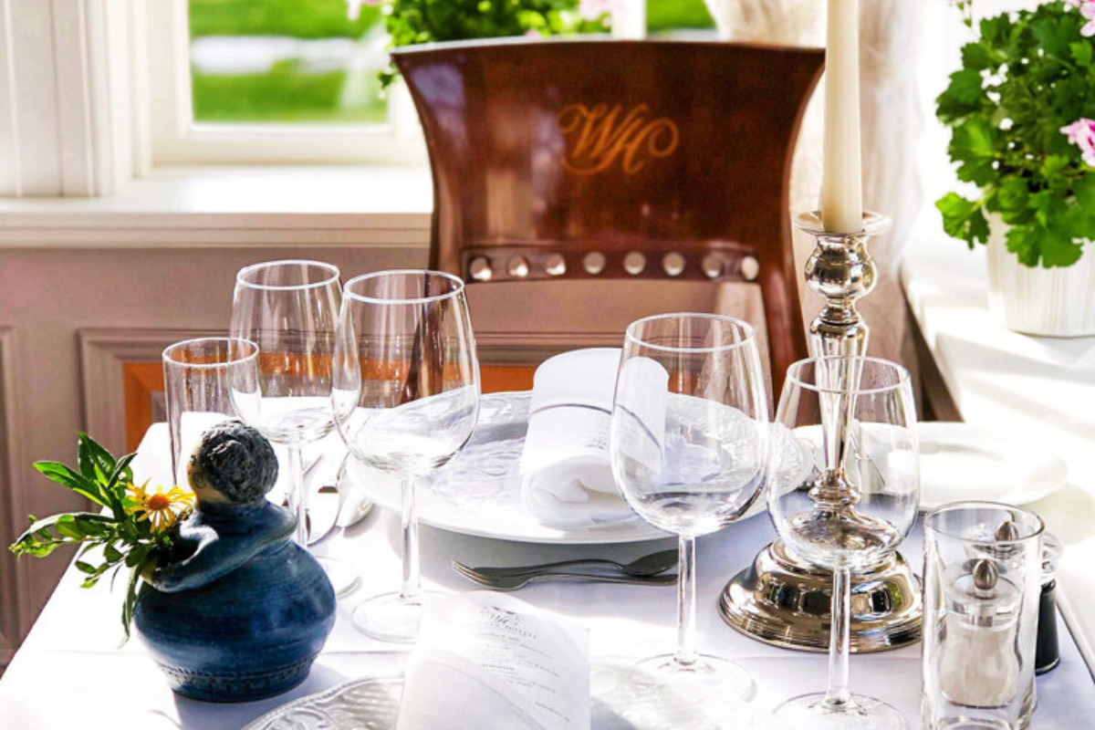 a table with wine glasses and candles