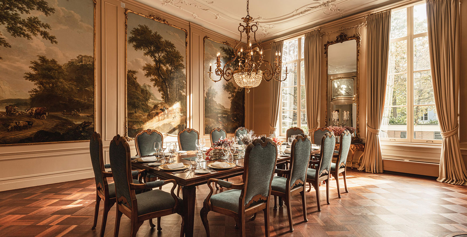 a dining room with a chandelier and a table set
