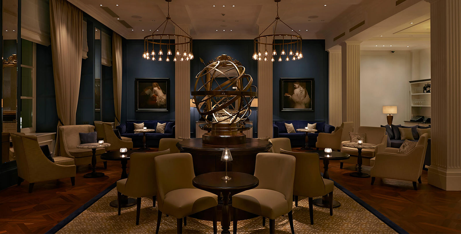 a room with a large globe and chairs