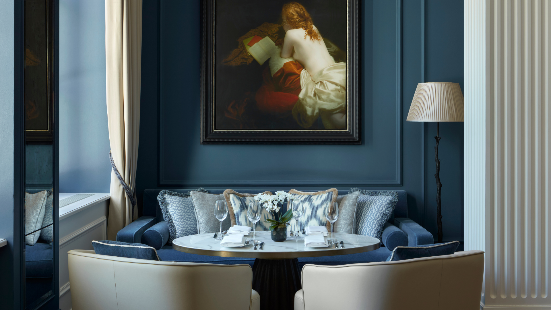 a table with a painting on the wall