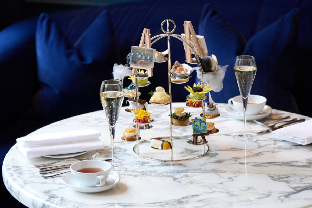 a table with a cup of tea and a glass of wine