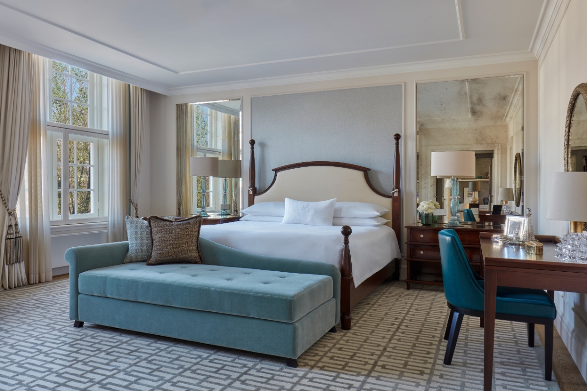 a bedroom with a bed and a blue couch