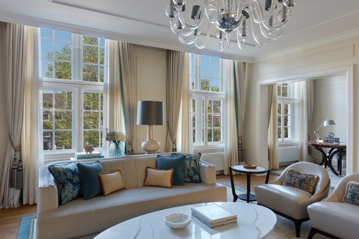 a living room with a chandelier and couches
