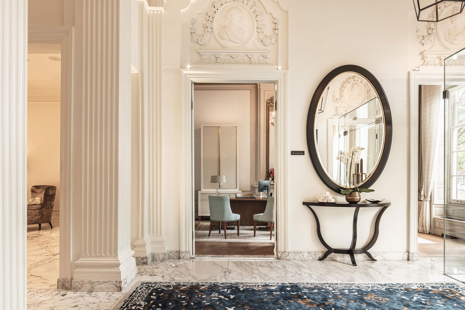 a hallway with a mirror and a rug