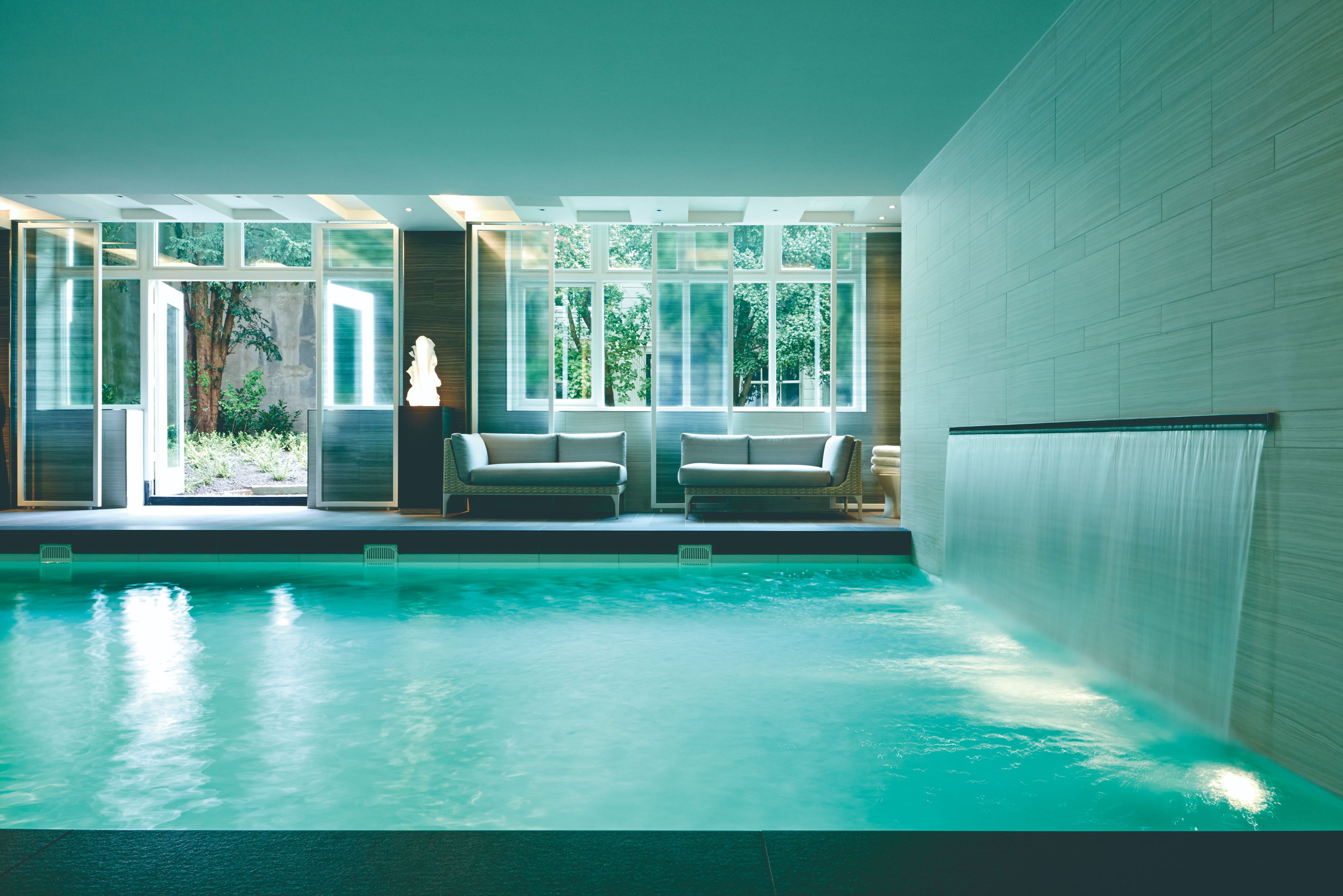 a indoor pool with a waterfall