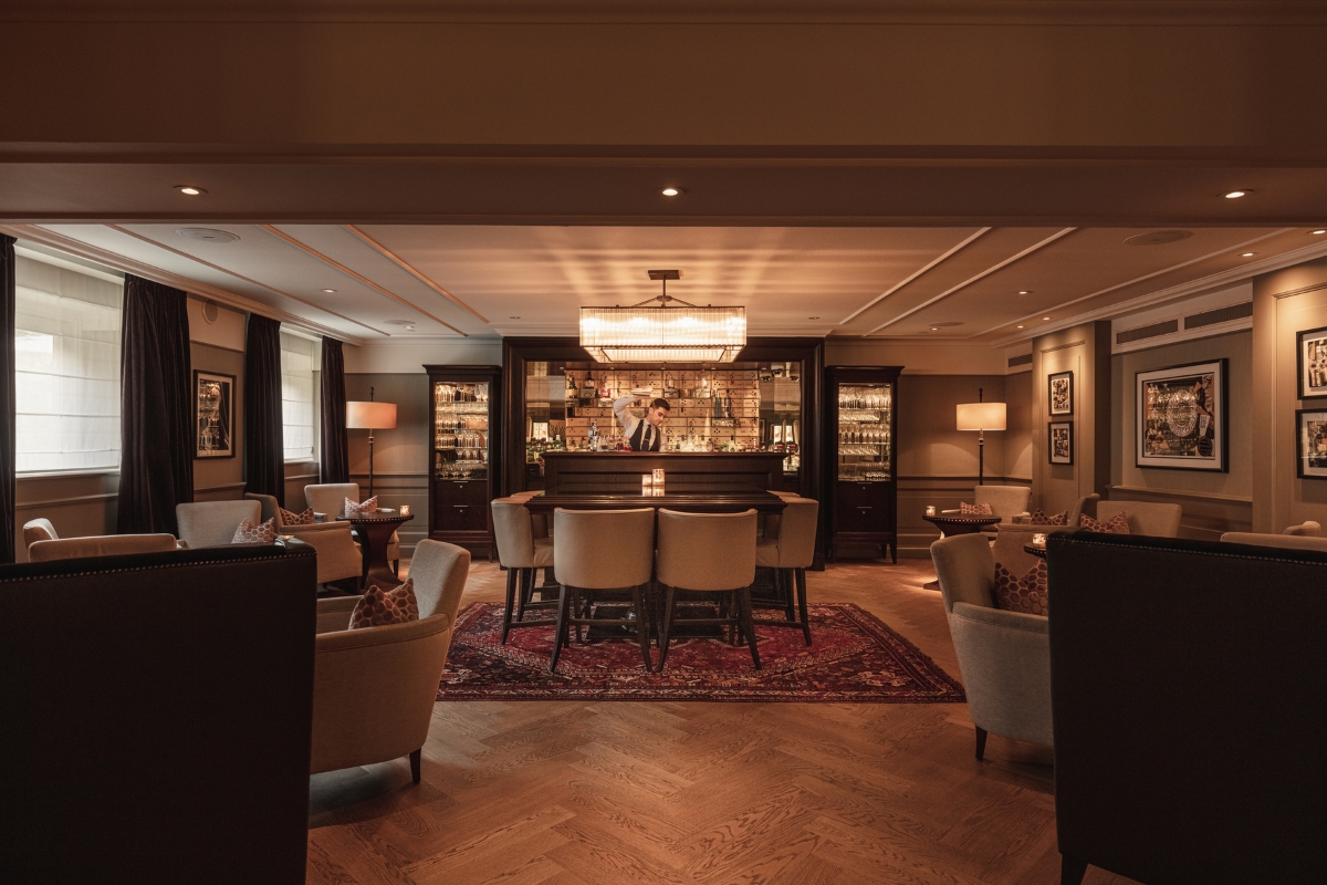 a room with a bar and chairs