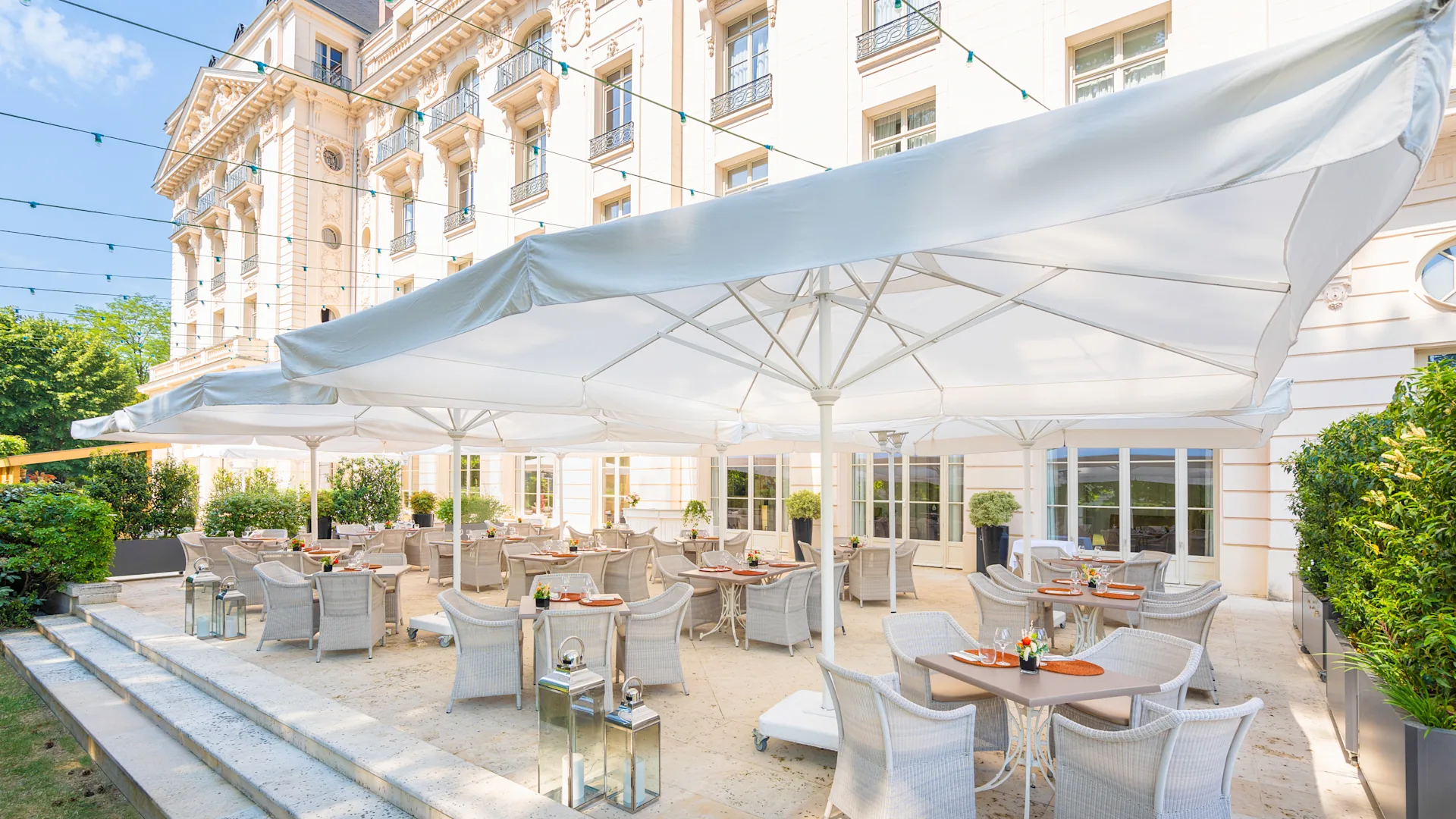 a white tent with tables and chairs outside