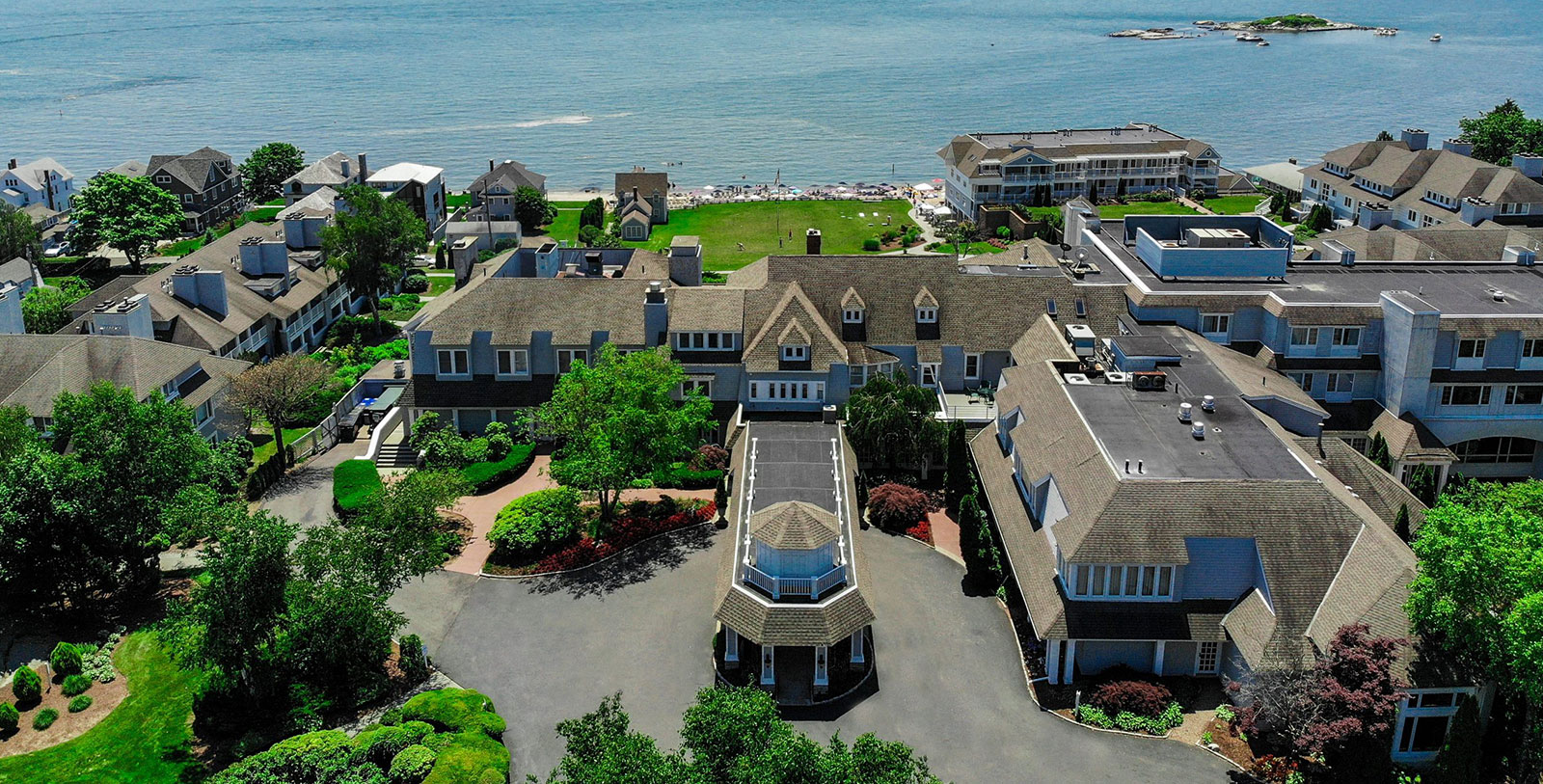 a large house with a large lawn and a large body of water