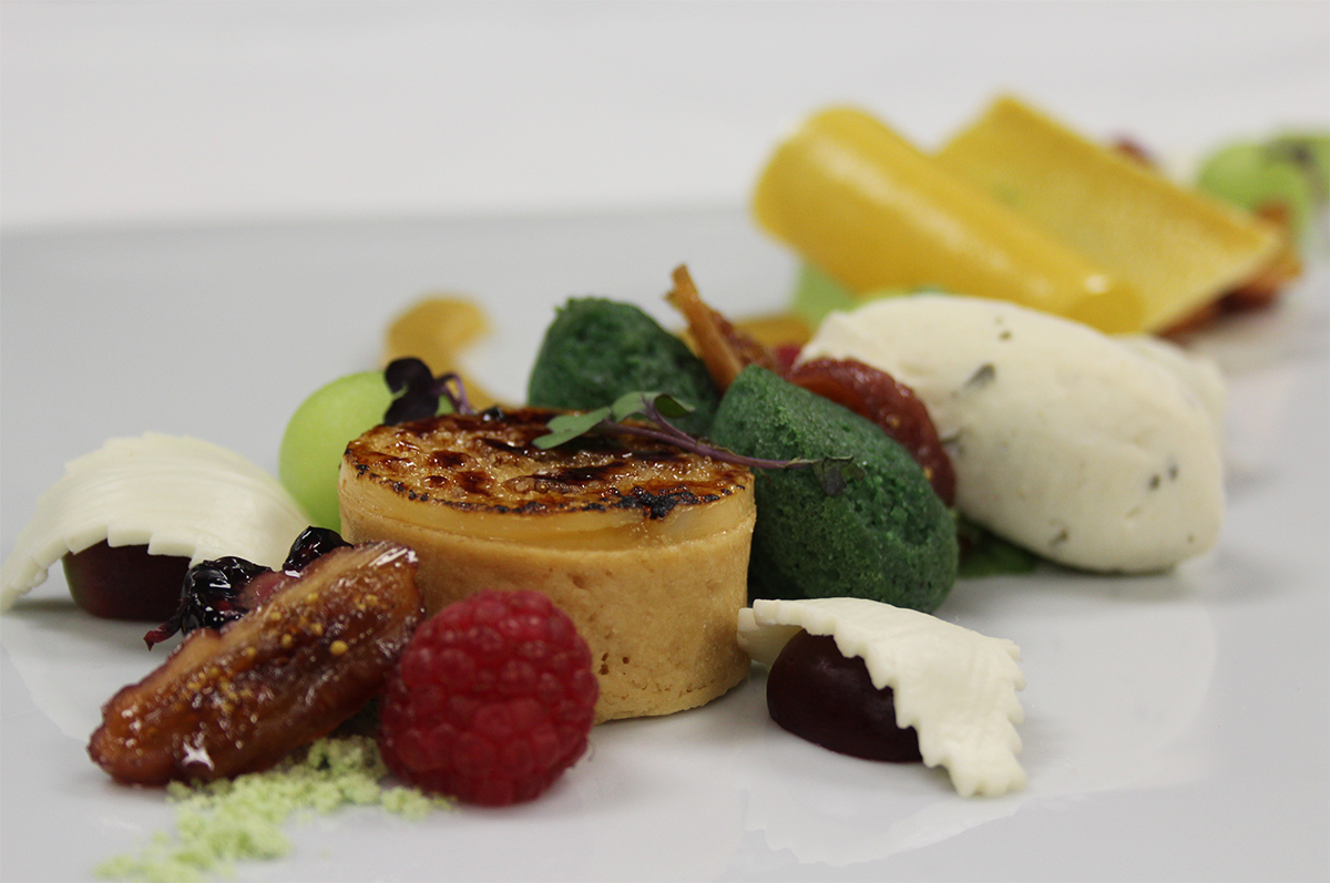 a plate of food with fruit and cheese
