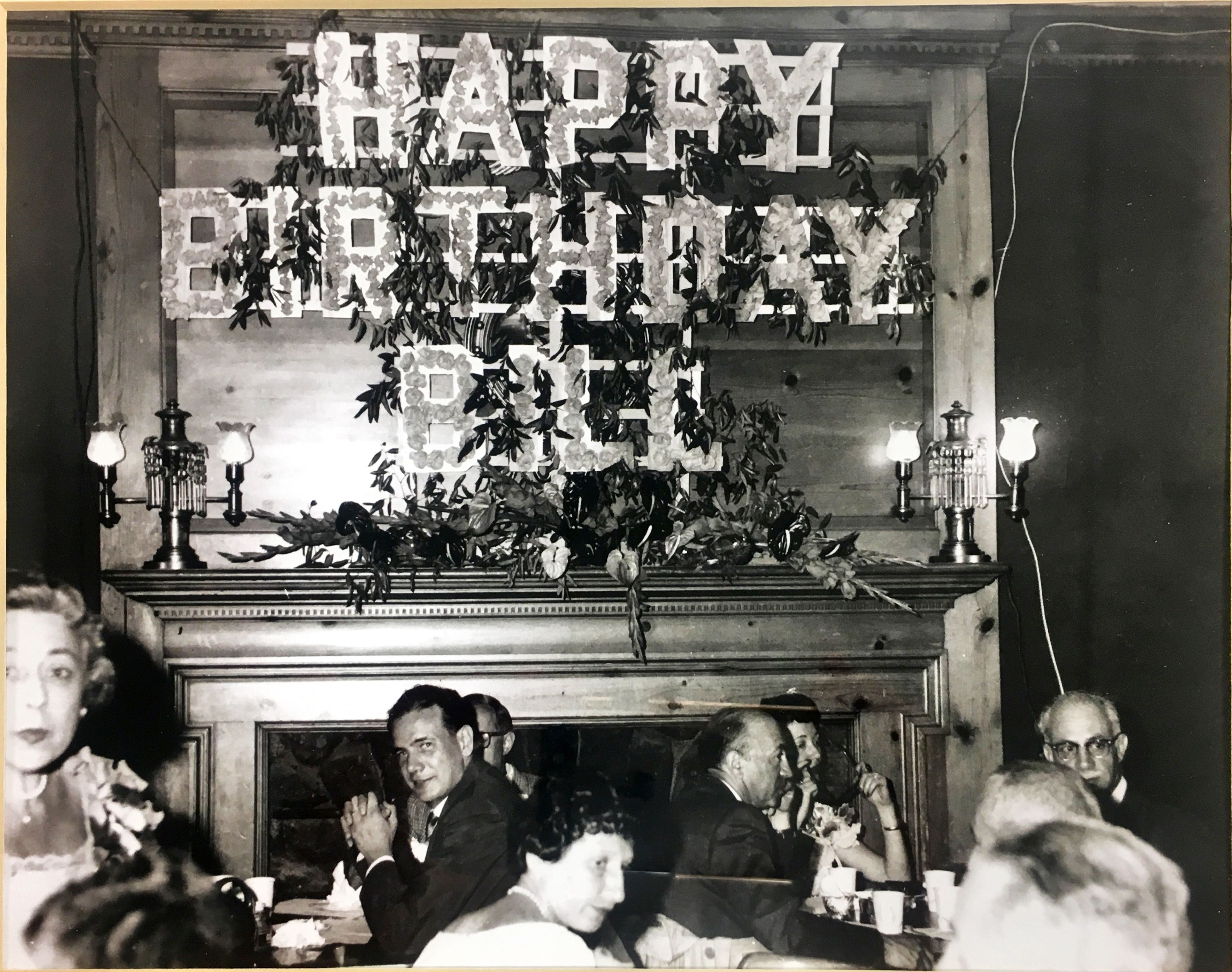 a group of people sitting around a fireplace