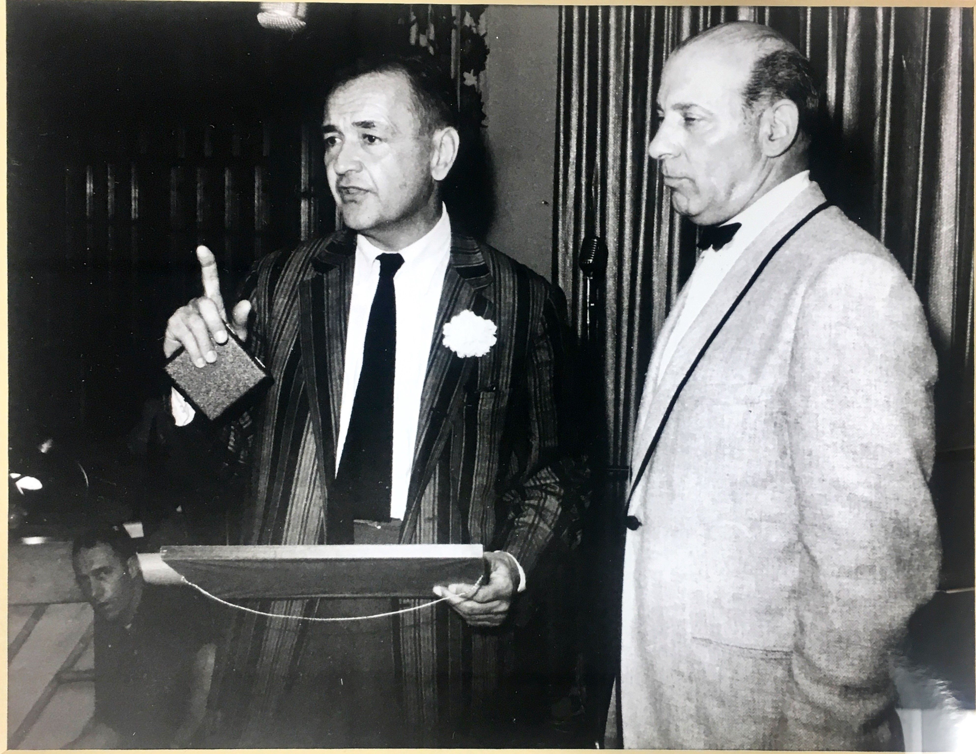 a man in a suit holding a box