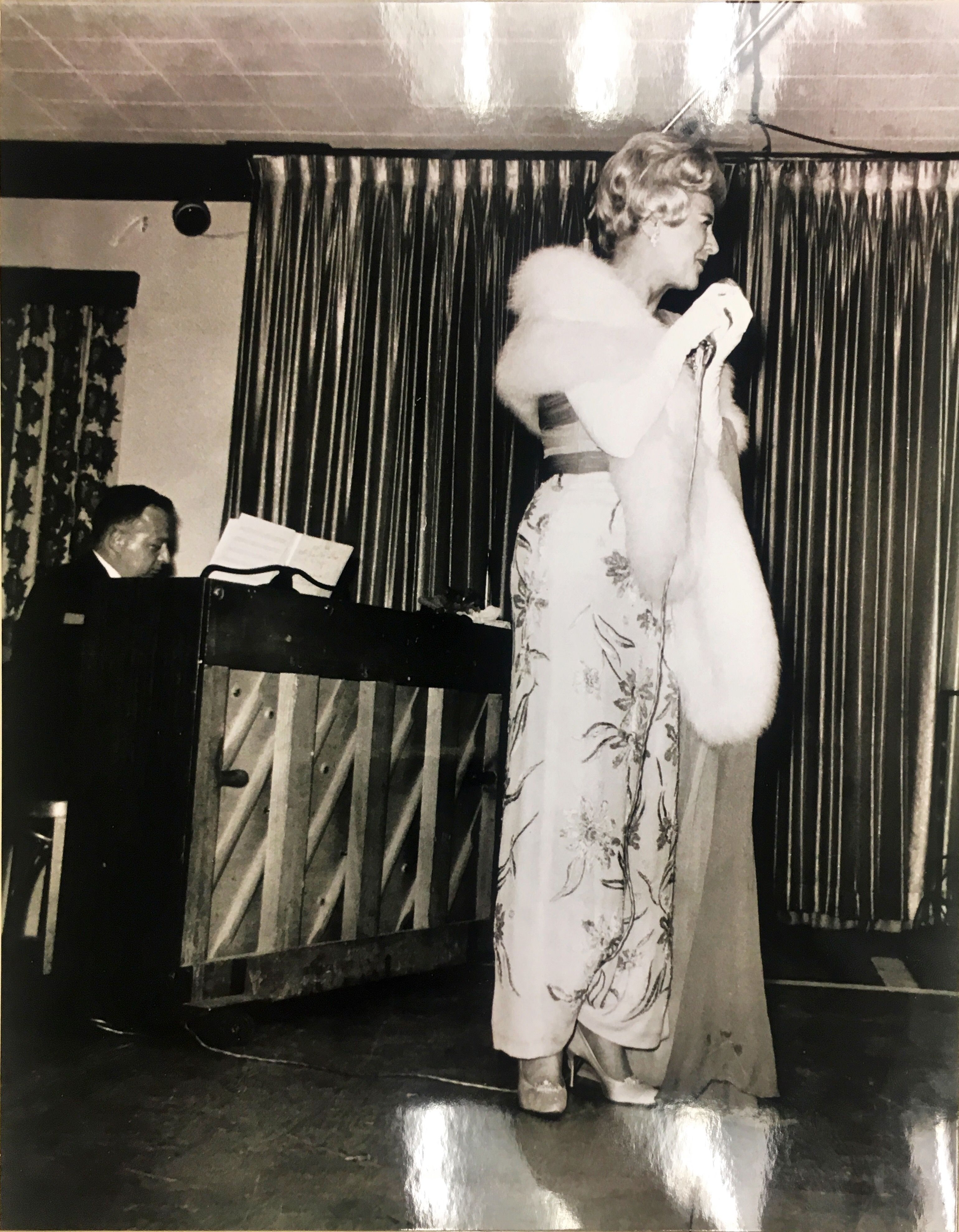 a woman in a dress with a fur collar