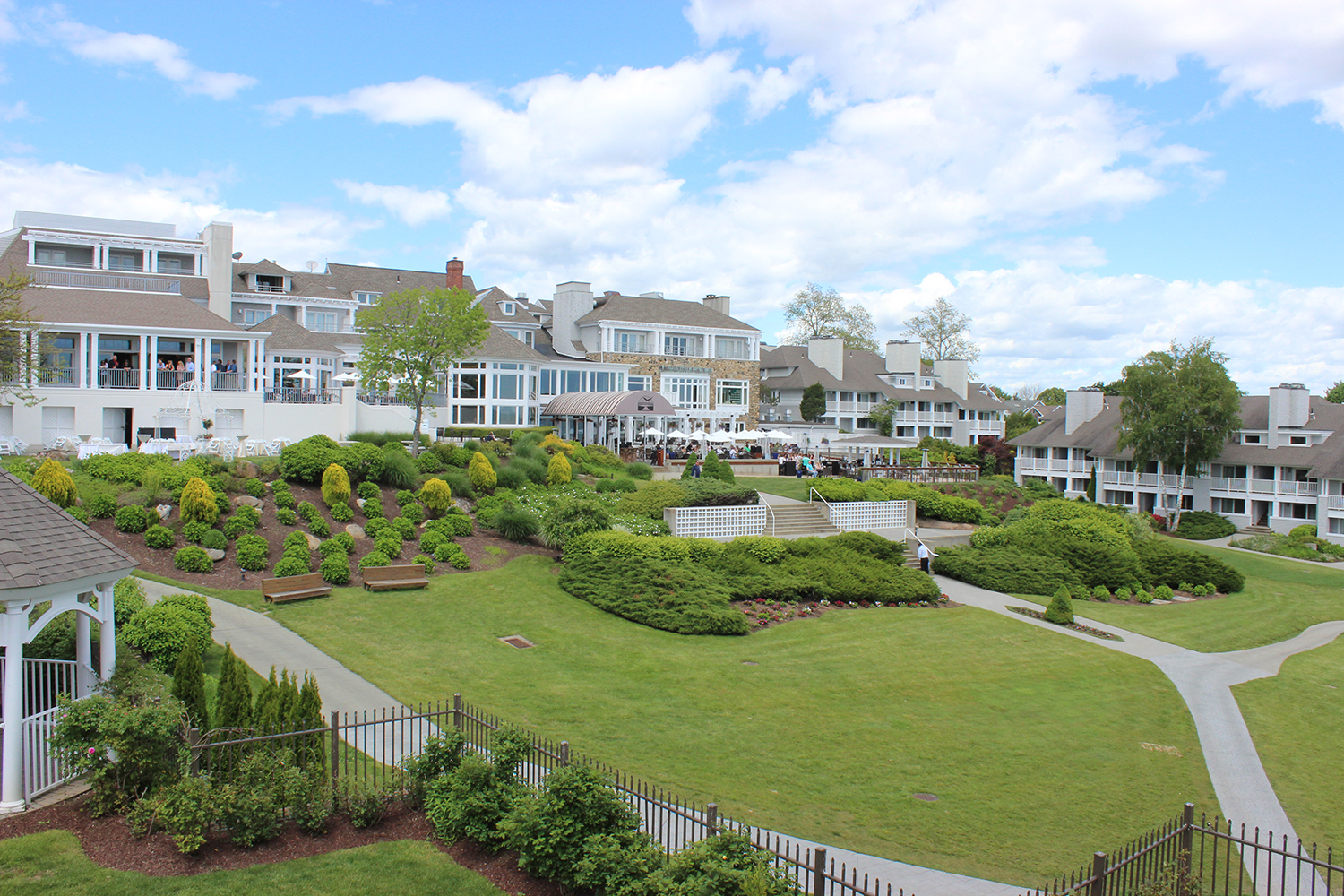 a large lawn with bushes and bushes in front of a building