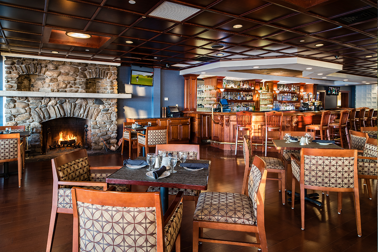 a restaurant with a fireplace and tables