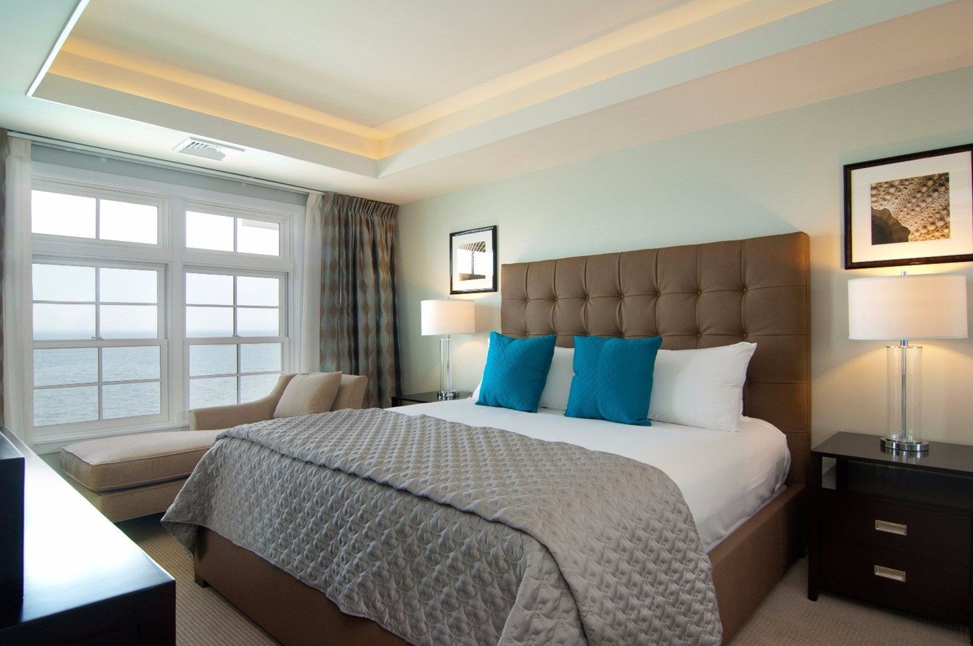 a bed with a headboard and a couch in a room