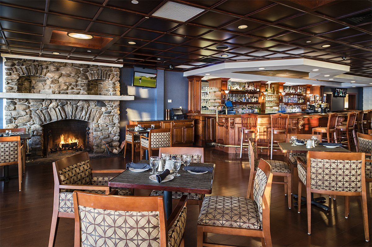 a restaurant with a fireplace and tables