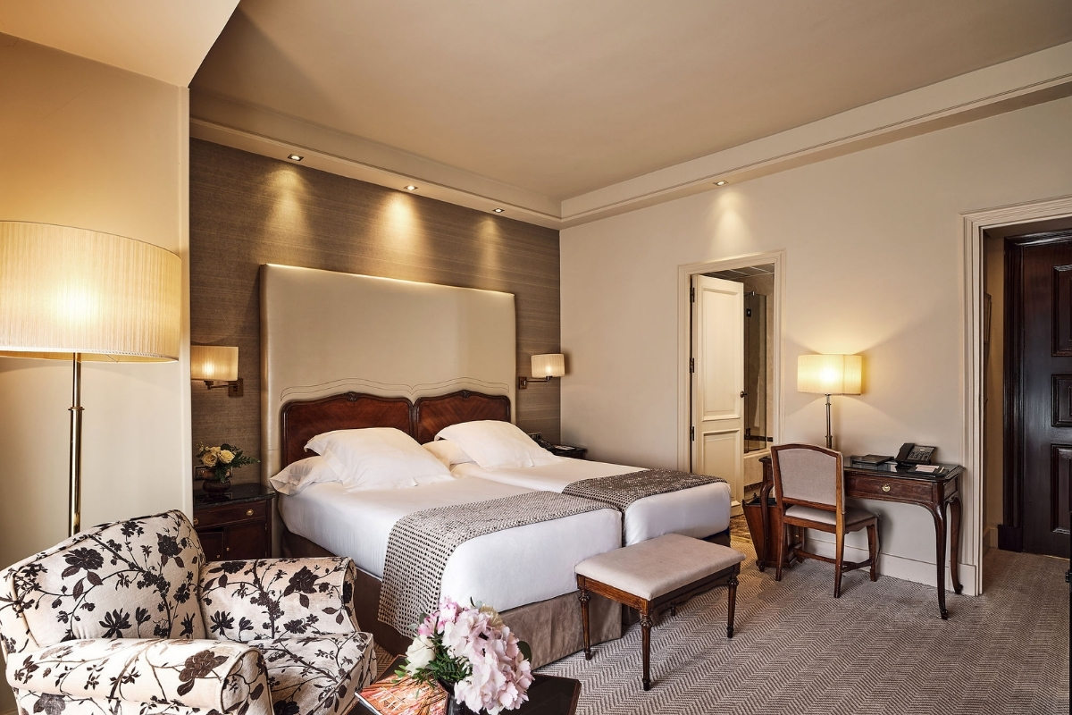 a bedroom with a bed and chairs