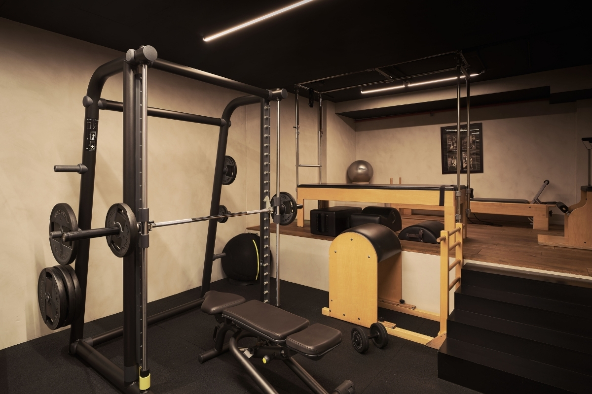 a gym with weights and a bench