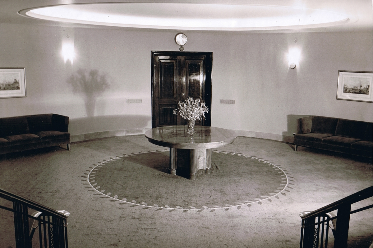 a round table with flowers in a room
