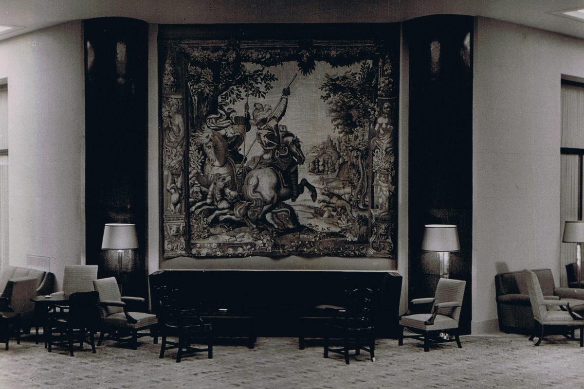 a room with a tapestry on the wall