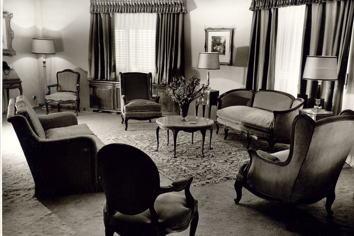 a living room with a table and chairs