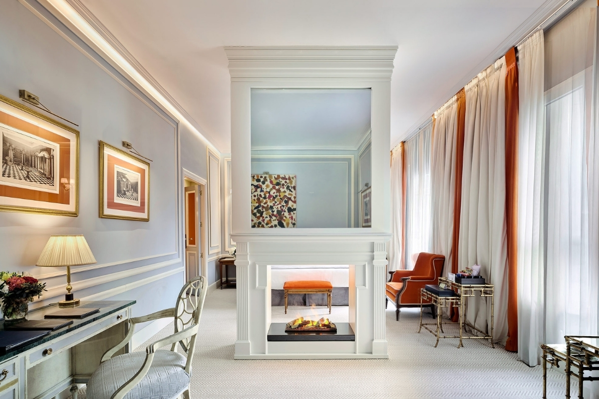 a room with a fireplace and chairs