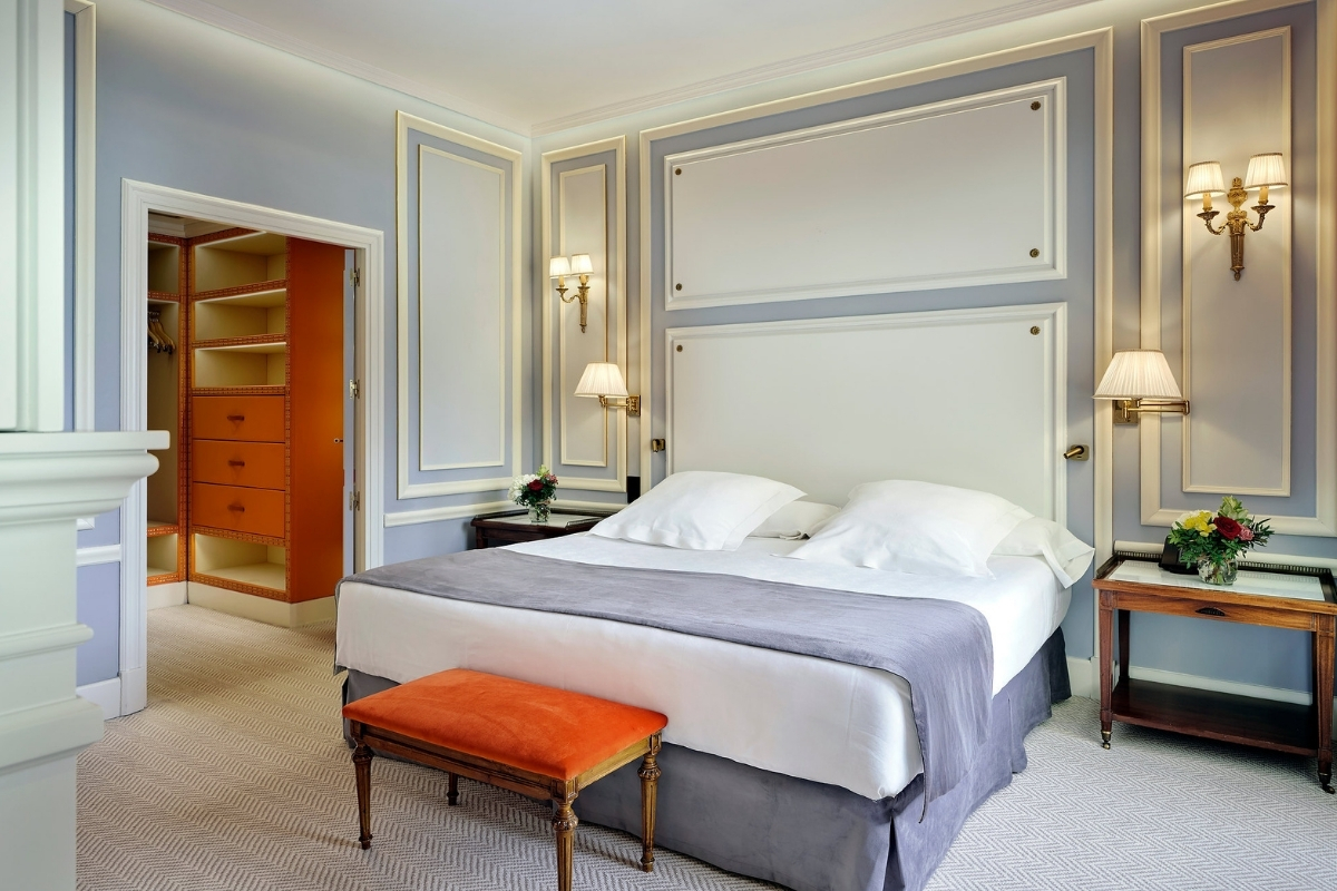 a bedroom with a bed and a chair
