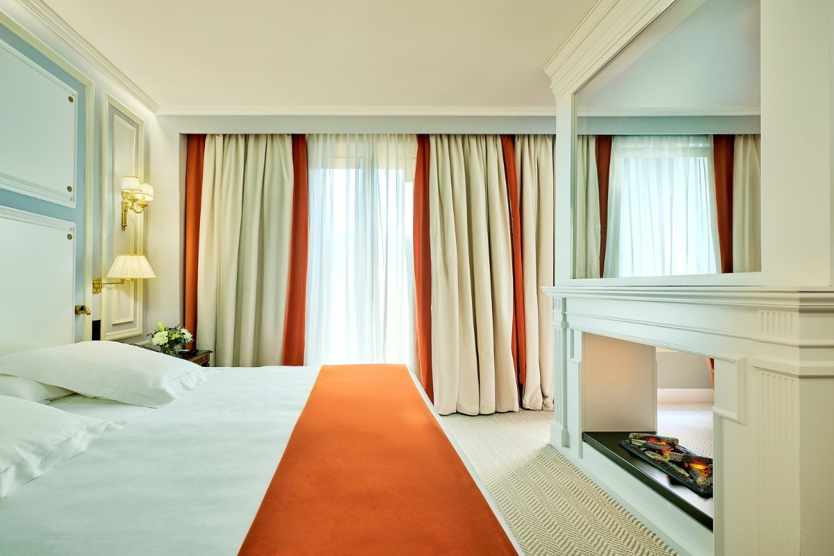 a room with a bed and fireplace