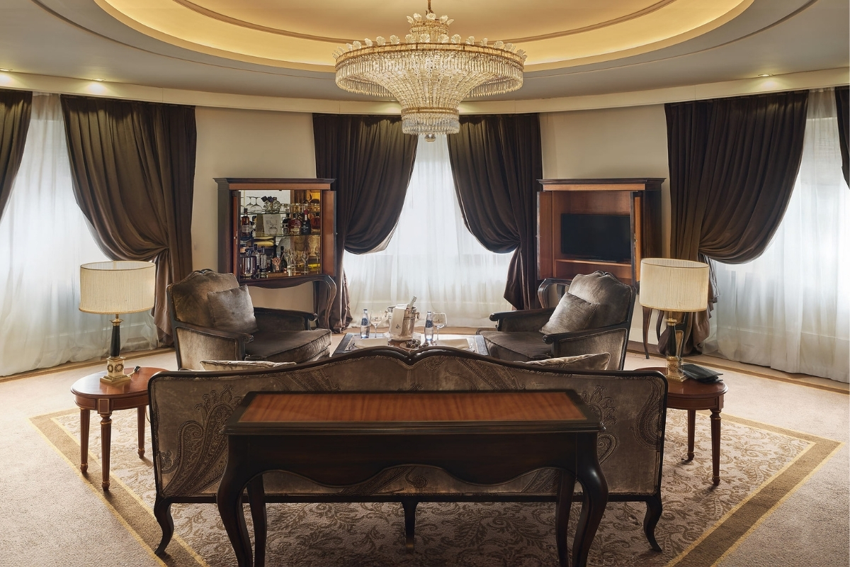 a room with a chandelier and couches