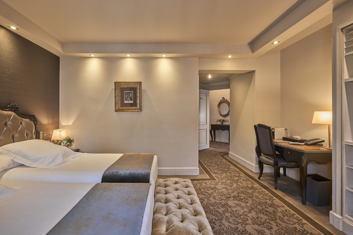 a room with two beds and a piano