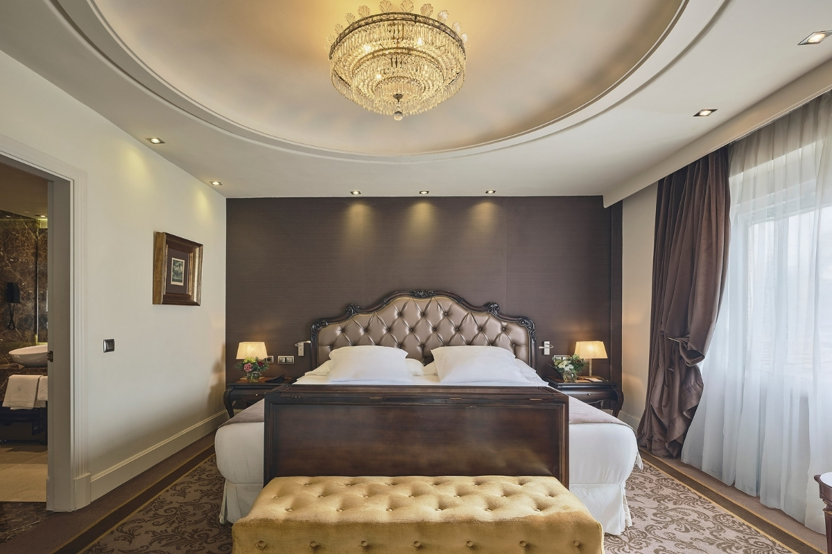 a bedroom with a chandelier and a bed