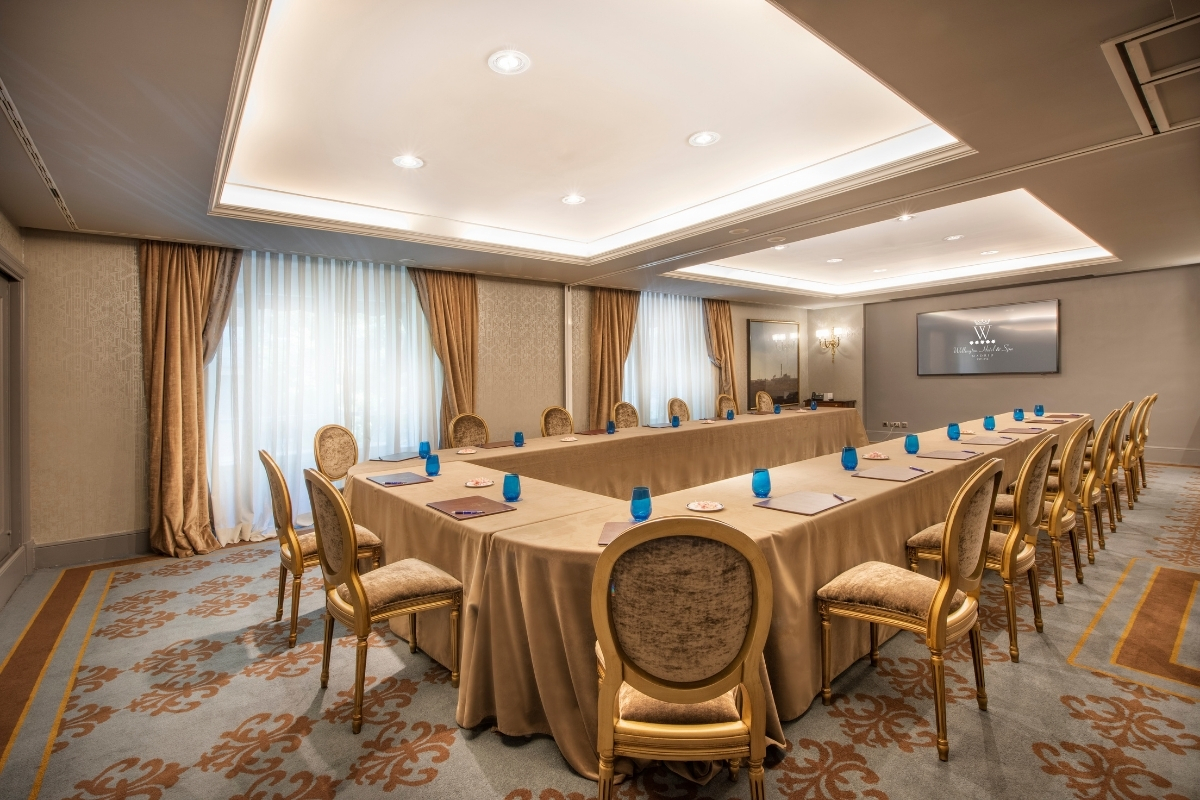 a room with a long table and chairs