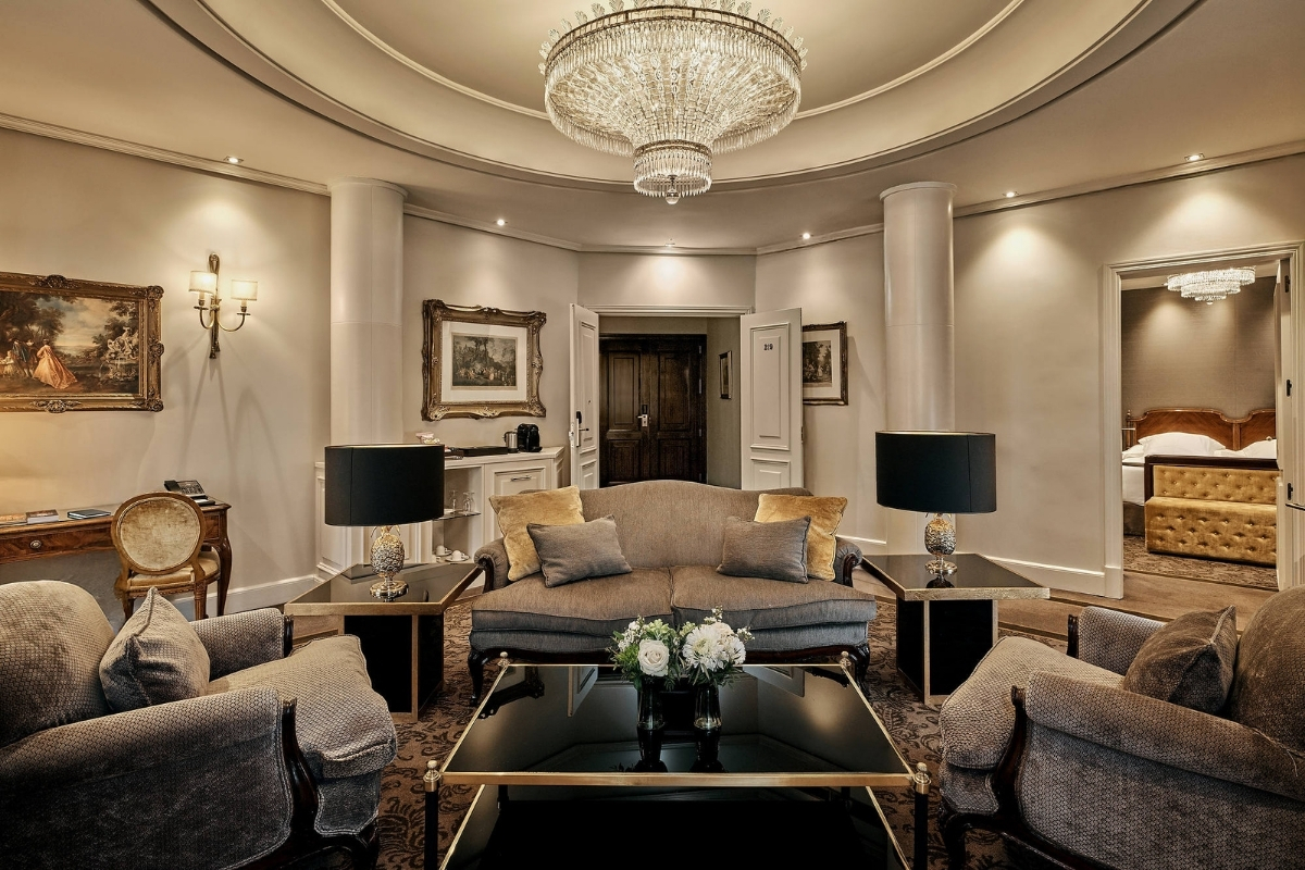a living room with a chandelier and couches