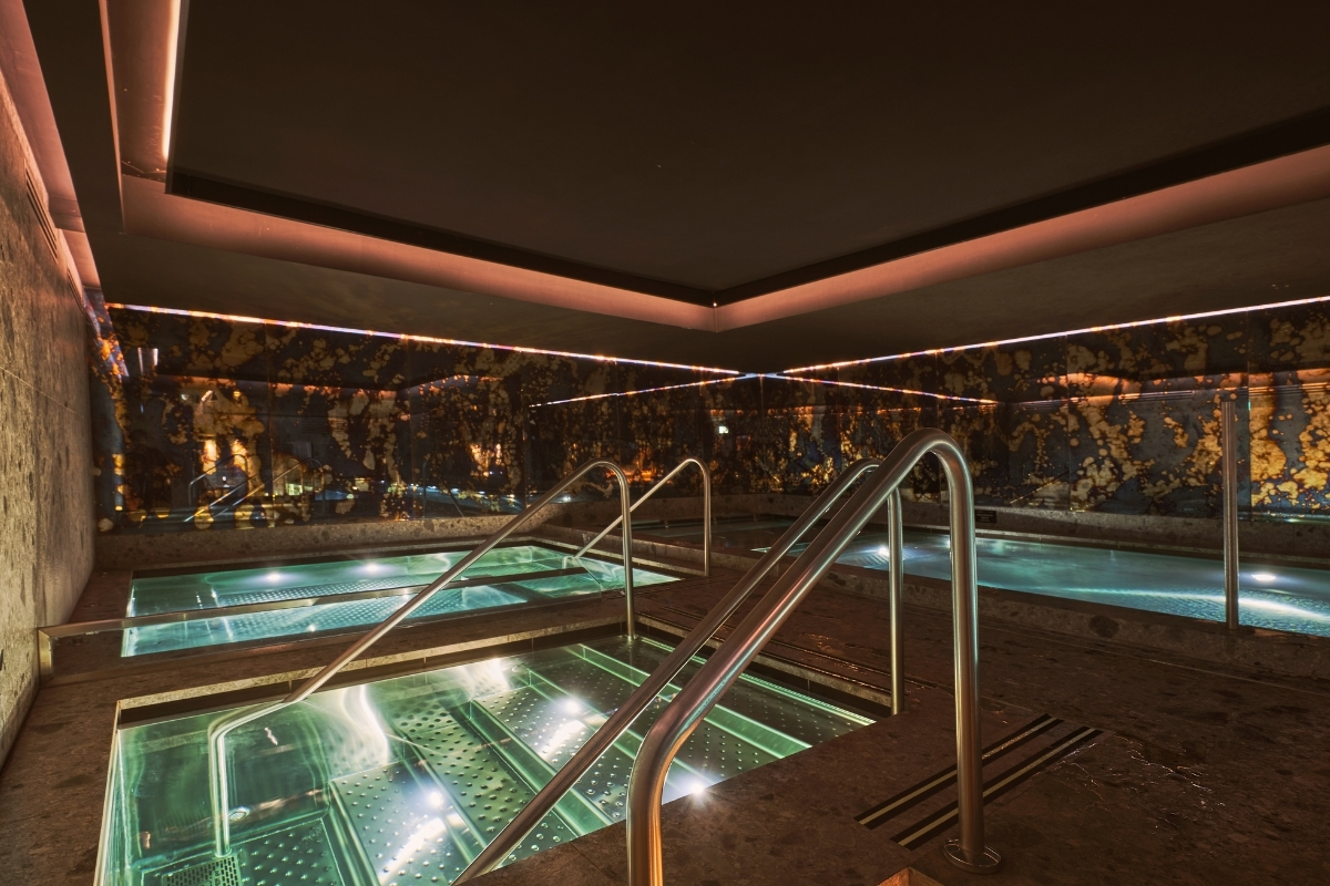 a swimming pool with metal railings