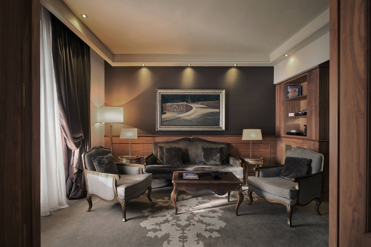 a room with a couch and chairs