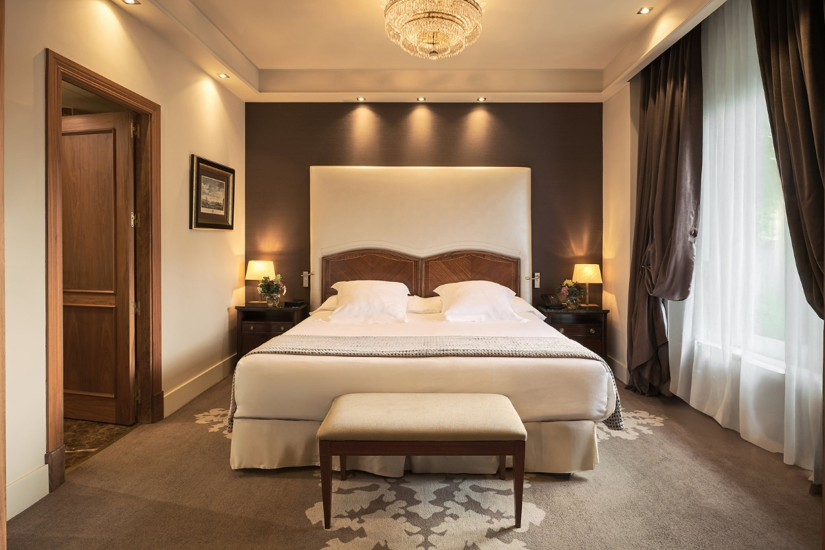 a bed with a chandelier in a room