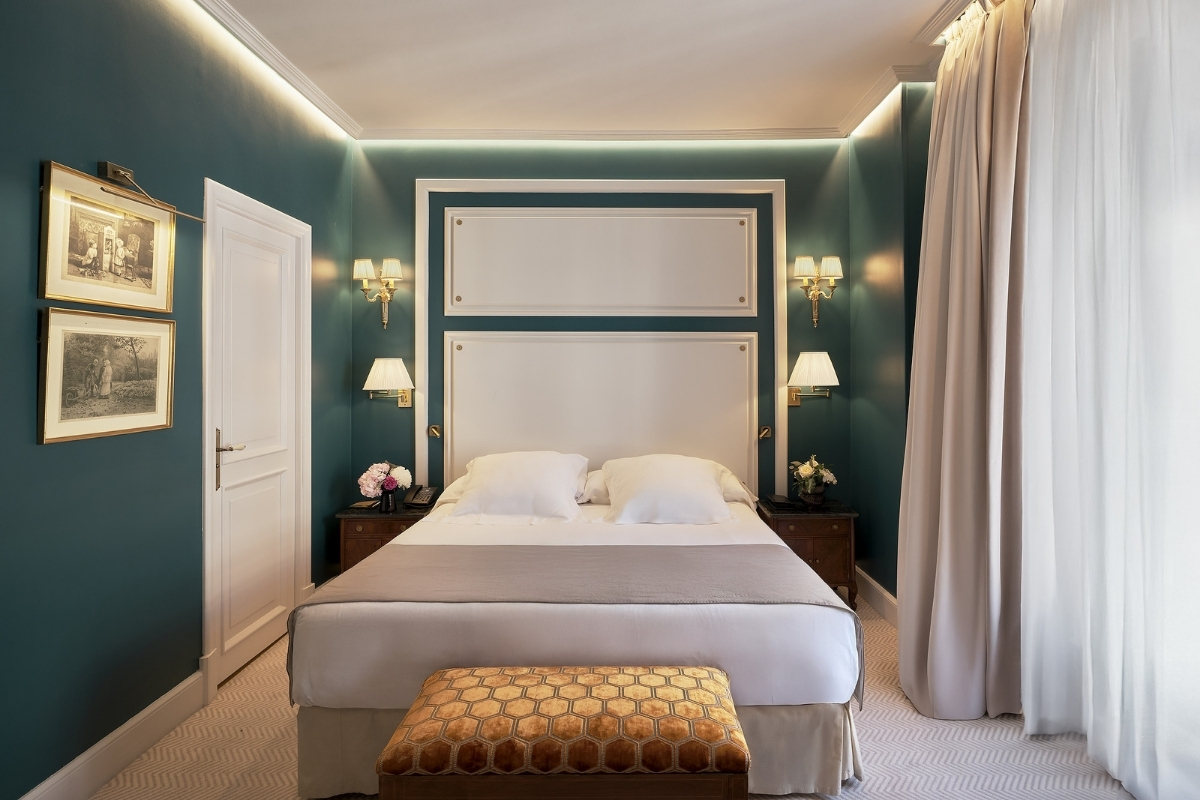 a bed with a bench in a room