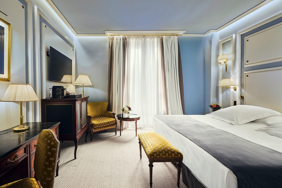 a room with a bed and a table and chairs