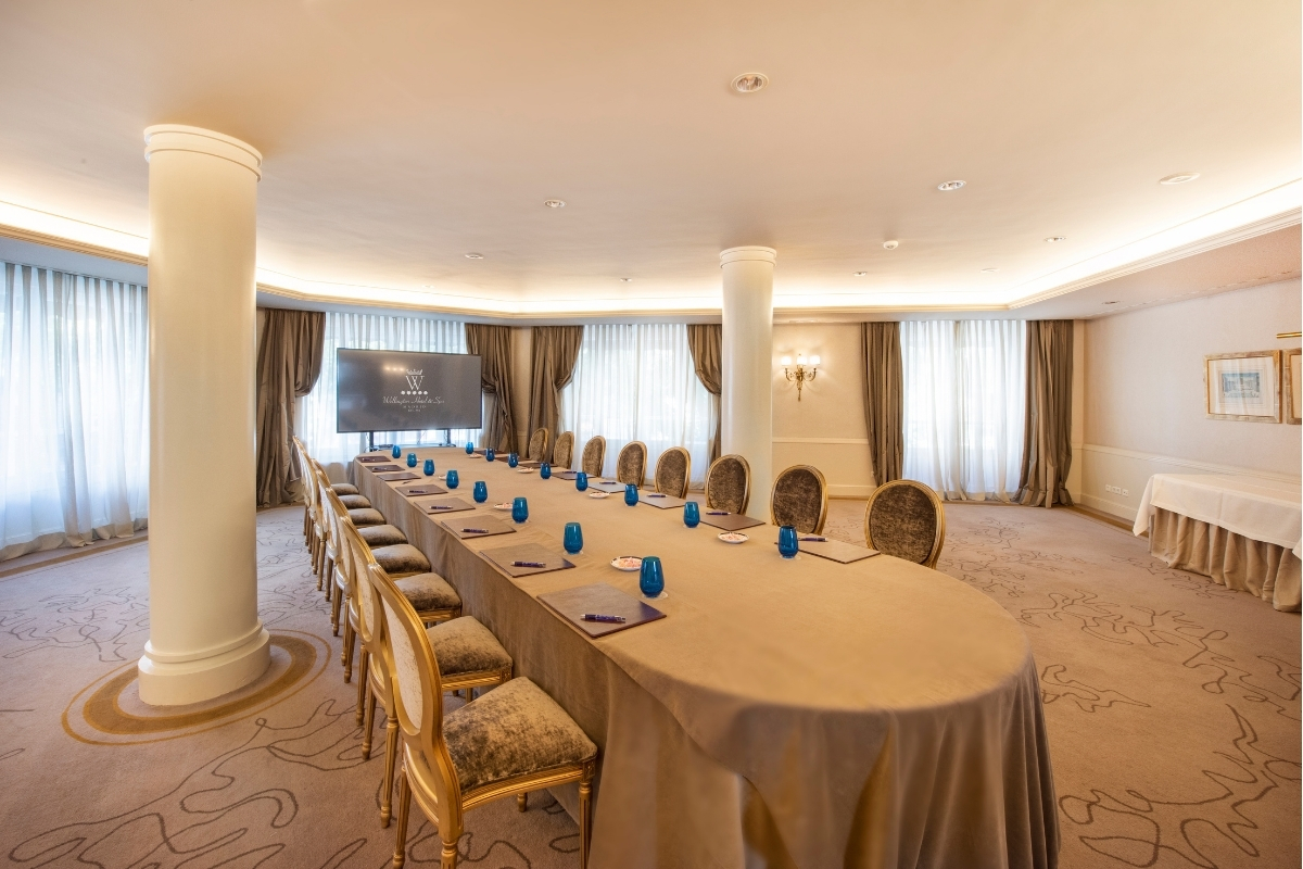 a long conference room with a table and chairs