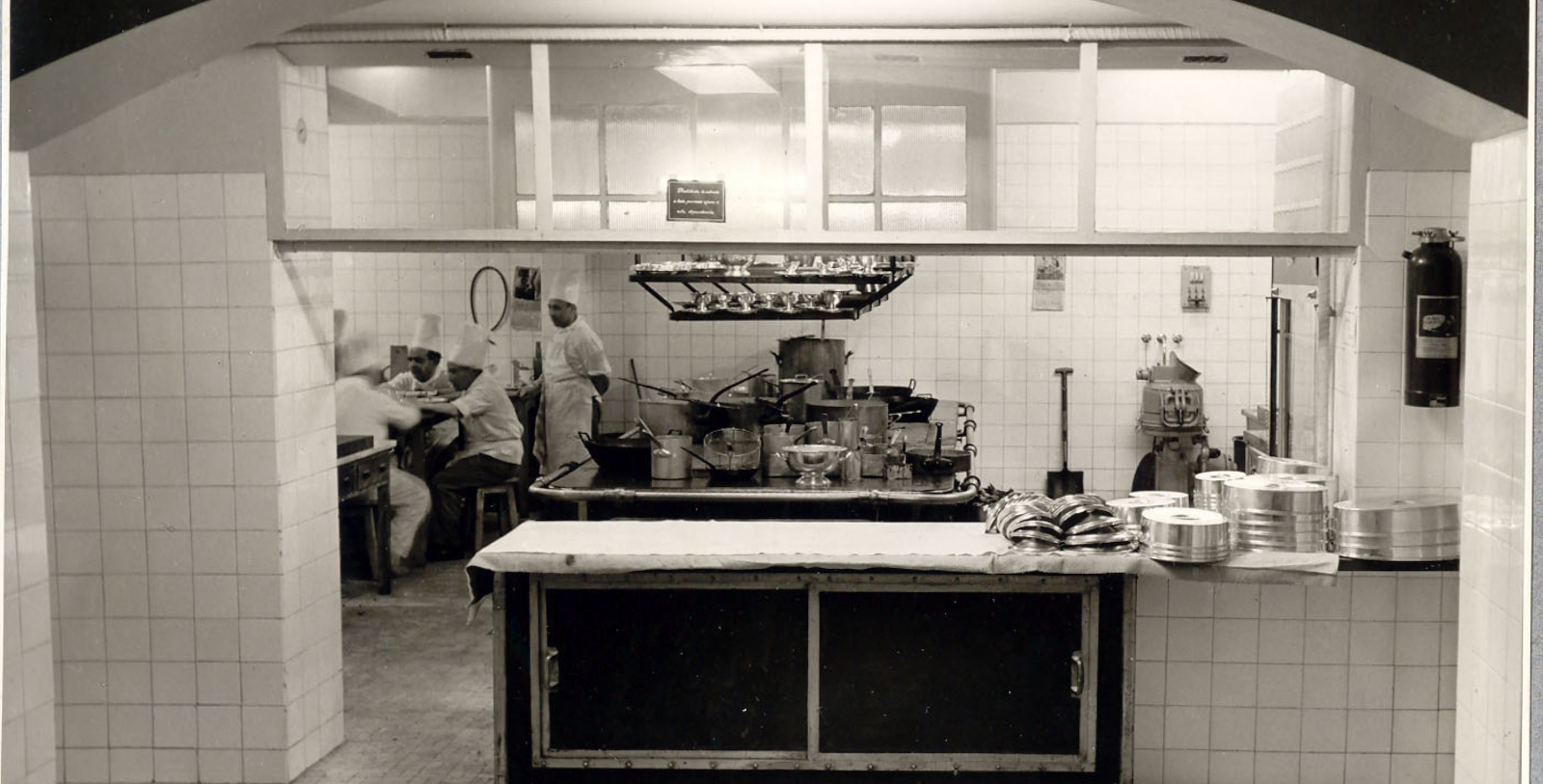 a group of chefs cooking in a kitchen