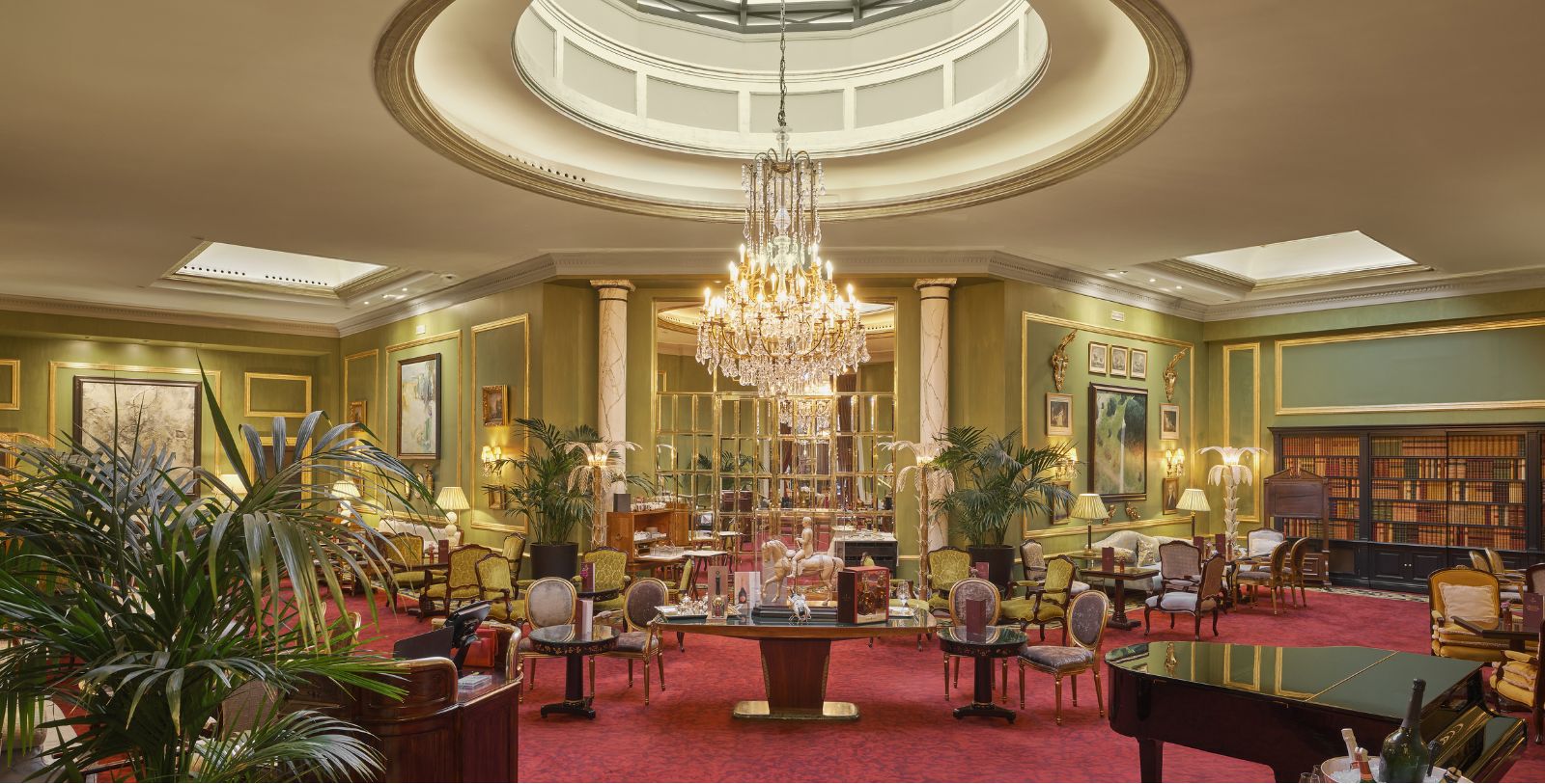 a room with a chandelier and tables