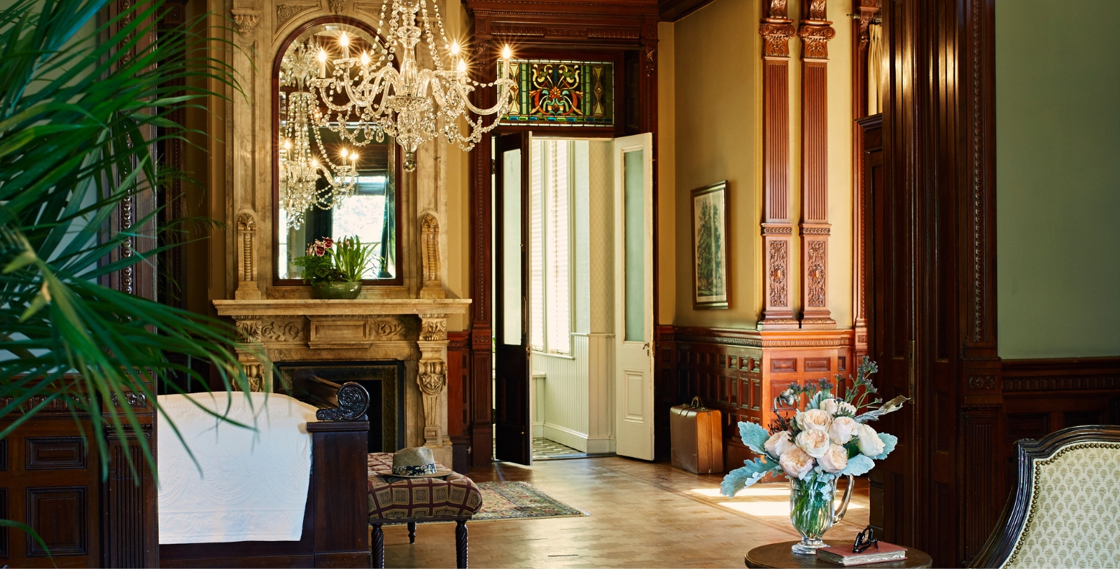 a room with a chandelier and a fireplace
