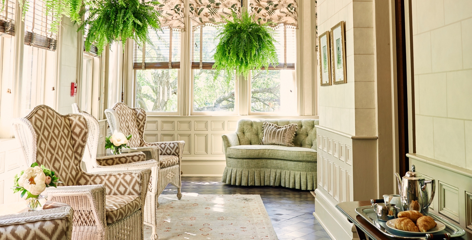 a room with a couch and chairs