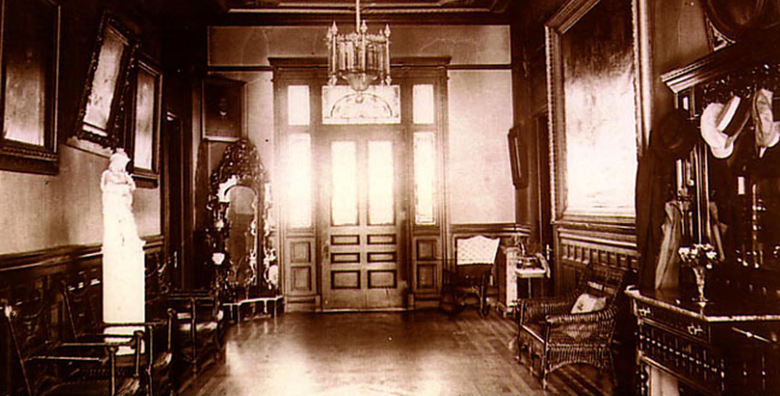 a room with a chandelier and a chair