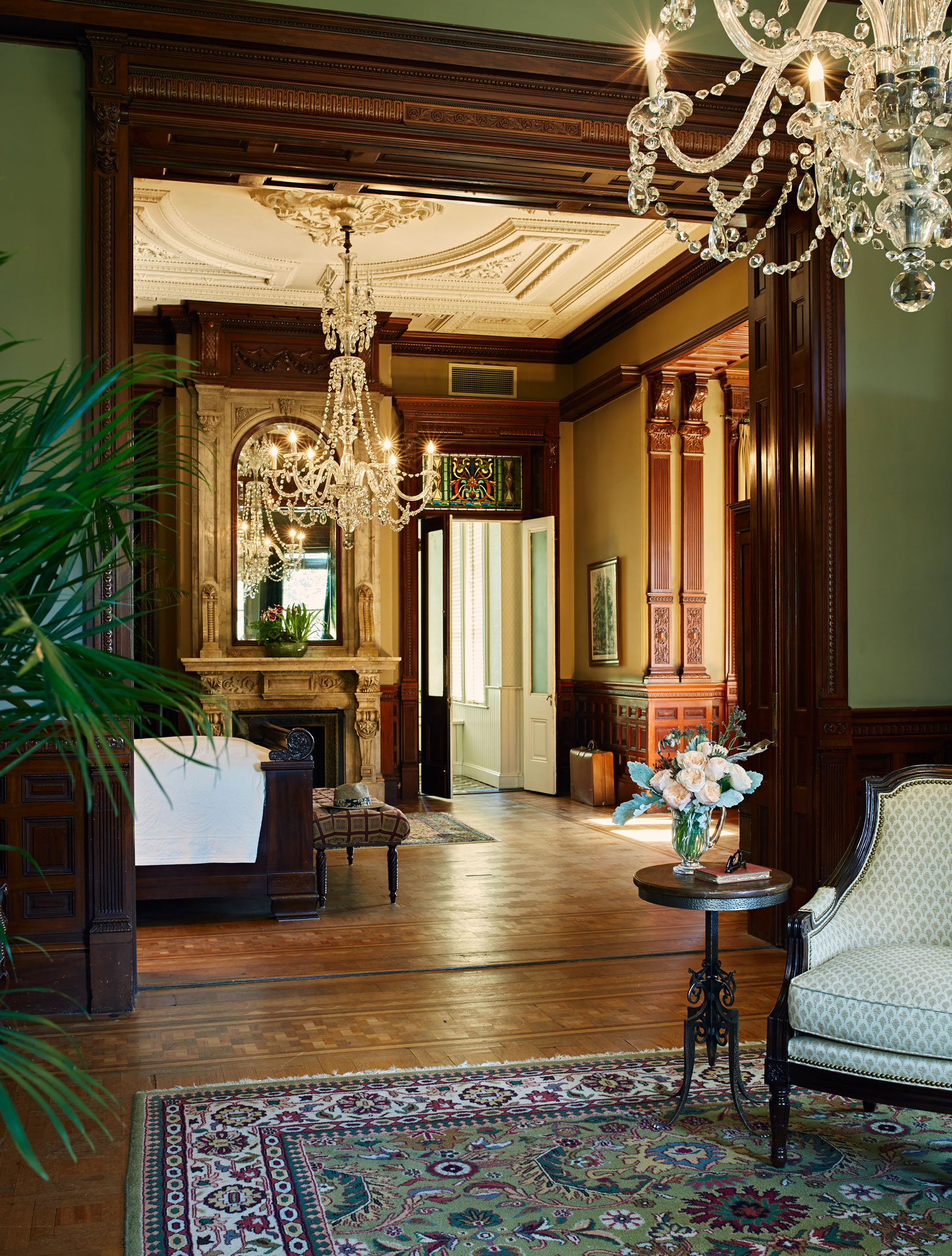 a room with a fireplace and chandeliers